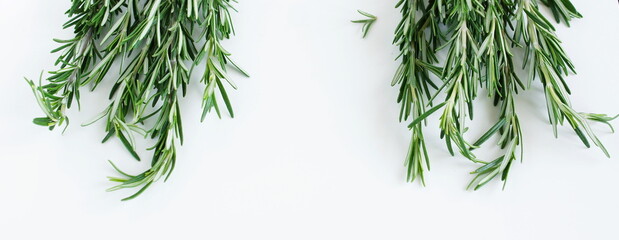 rosemary leaves frame top view on white table. Copy space. Food concepte.