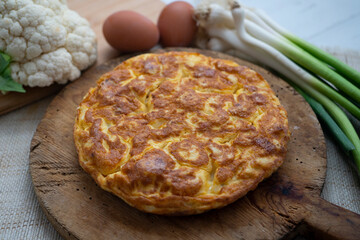 Traditional Spanish omelette with cabbage and Iberian ham.