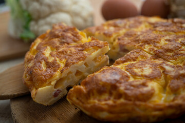 Traditional Spanish omelette with cabbage and Iberian ham.
