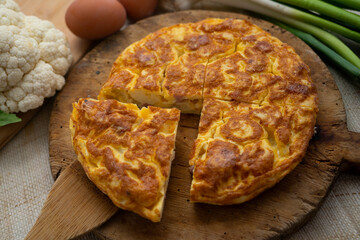 Traditional Spanish omelette with cabbage and Iberian ham.