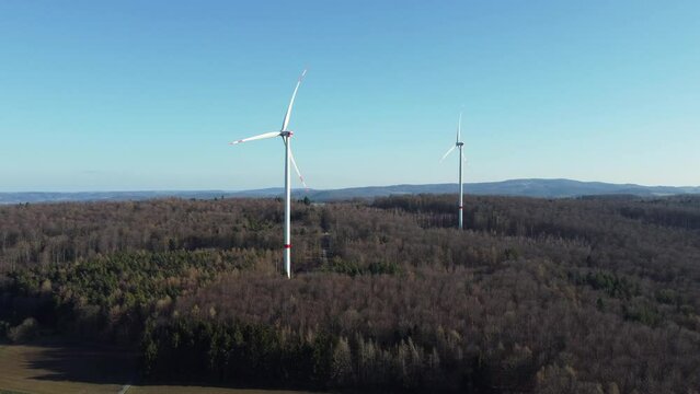 Drone flyby of wind farm or wind park with high wind turbines for generating electricity