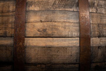 Old wooden barrel texture background. Wine or beer cask close up. Weathered, aged, rusty, vintage...