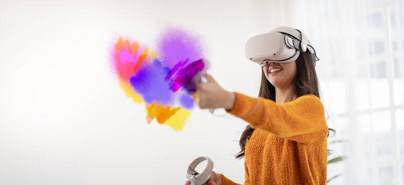 VR metaverse concept.Beautiful Artist woman in glasses of VR(virtual reality) Augmented reality.Girl wearing VR headset Working on Abstract 3D Sculpture with Controllers To Create NFT art in metaverse