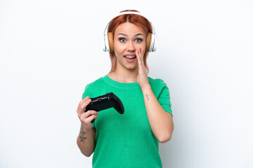 Young Russian girl playing with a video game controller isolated on white background with surprise and shocked facial expression