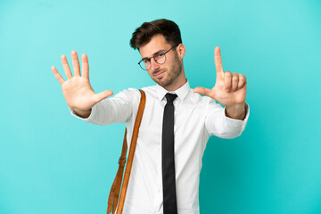 Business man over isolated background counting seven with fingers