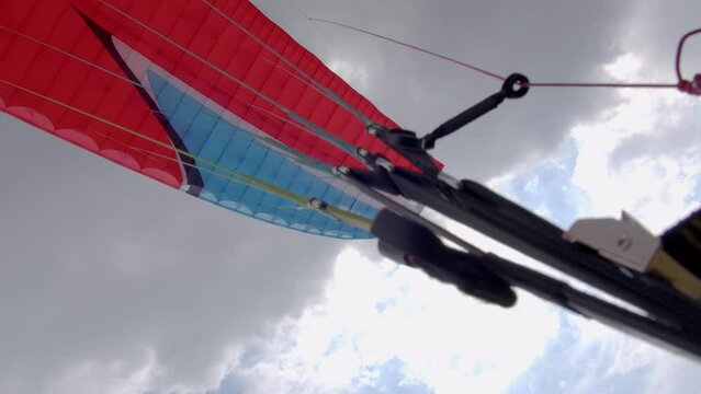 Paragliding. Extreme sport. Detailed shot of a paraglider flying in the sky. 4k