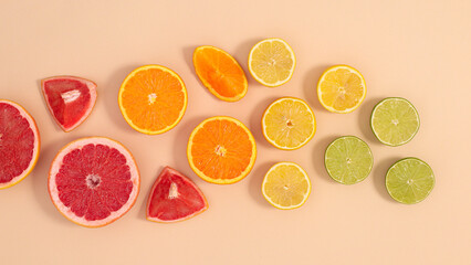 Summer fruits creative layout on pastel beige background. Flat lay citrus composition