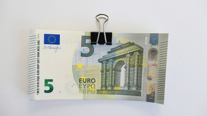stack of 5 five euro banknotes with letter foldback clip - isolated 