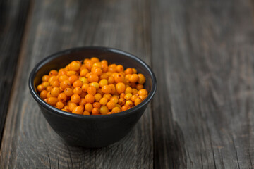 orange sea buckthorn berries on wooden table. copy space