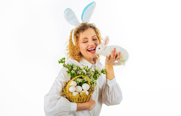 Smiling Girl in bunny ears with basket eggs and Easter bunny rabbit. Religion symbol. Spring holiday.