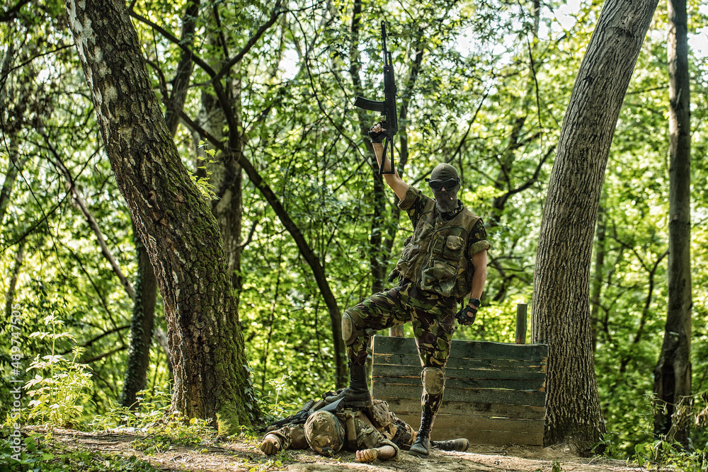 Wall mural Dead soldier. Killed russian or ukrainian soldiers. Army soldier with rifle and machine gun.