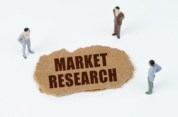 On a white background, figures of businessmen and torn cardboard with the inscription - Market Research