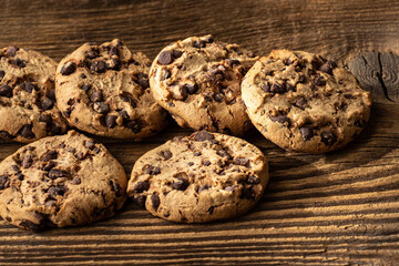 Chocolate chip cookies on wooden table.