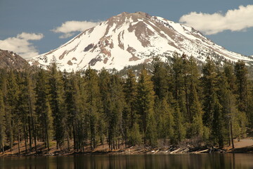 Lassen Peak with snow viewed from Reflection Lake in Lassen Volcanic National Park, California