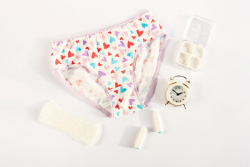 Women's underwear and menstrual intimate hygiene products. Concept of menstruation, woman's health, menstrual cycle. Critical days,  pain, gynecology, female diseases, premenstrual syndrome. Top view