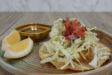 Cod beer battered taco stacked tall with breaded fish and cole slaw