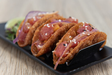 Tasty appetizer of ahi poke tacos in a crispy shell to eat before your meal