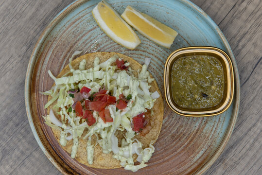 Overhead View Of Cod Beer Battered Taco Stacked Tall With Breaded Fish And Cole Slaw