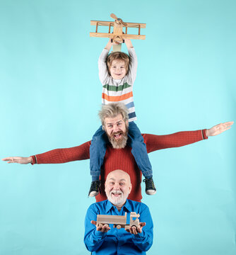 Fathers day. Kid having fun with toy plane. Men generation family with three different generations ages grandfather father and son. Journey travel trip concept. Generations family.