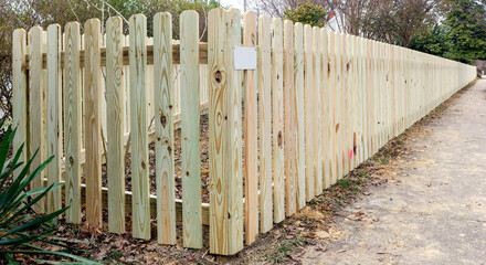 New wooden picket fence showing perspective.