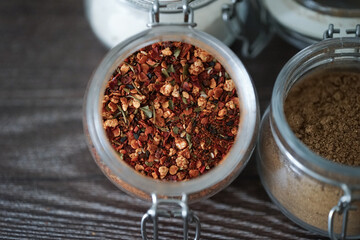 Hot spices in glass jars on a dark background