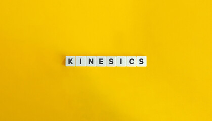 Kinesics Word on Letter Tiles on Yellow Background. Minimal Aesthetics.