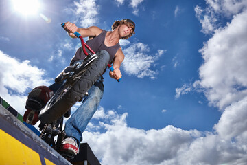 Practicing for the x games. Full length shot of a teenage boy riding a BMX at a skatepark.