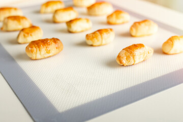Fresh sweet dessert pastries on a baking mat with copy space