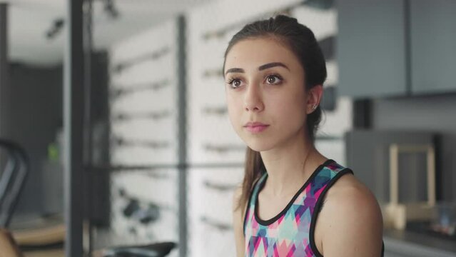 video portrait of a beautiful girl smiling in a fitness club