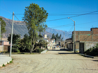 Fototapeta na wymiar A deserted street with a dirt road.