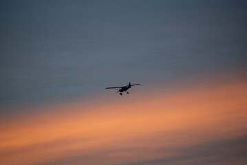 Fototapeta na wymiar airplane flying in the sky, sunset