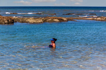 Woman alone enjoying the calm blue sea 