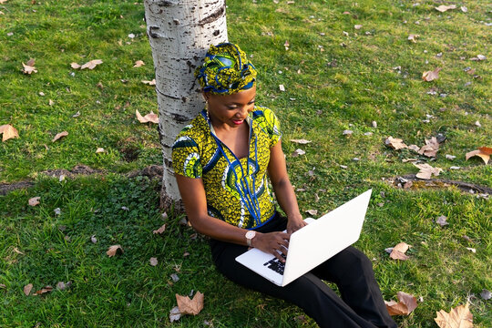 Black Woman Using Laptop In Park