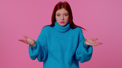 I dont know what to say. Confused pretty redhead teen girl feeling embarrassed about ambiguous...