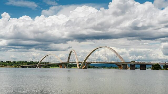Zoom out time lapse view of dramatic skies over JK Bridge by day in Brasilia, Federal District and capital of Brazil, South America. 