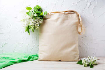 Rustic tote bag mockup with white lilac branches