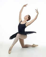Obraz premium elegant ballerina made a deflection. photo shoots in the studio on a white background