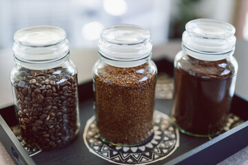 jars of coffee beans next to jar of instant coffee, best tasting option and coffee culture