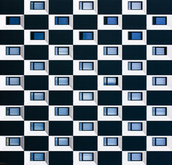 windows on a black and white facade