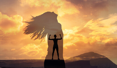 woman feeling strong and motivated standing on mountain peak. Overcoming your fears and finding strength 