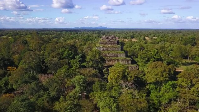 Tourists atop the old ruins of Koh Ker, an ancient temple in the remote jungle of northern Cambodia. Aerial flyover