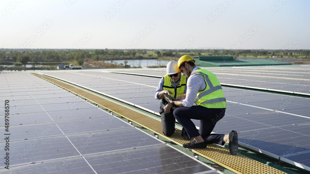 Wall mural professional engineer using drone and digital tablet maintaining solar cell panels together on build