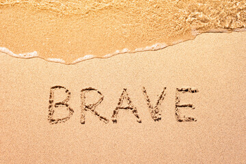 Be brave message written in the sand. self improvement, and success concept. 