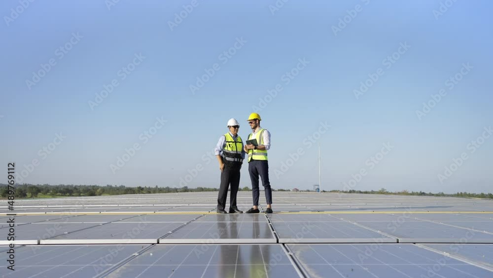 Wall mural professional engineer using drone and digital tablet maintaining solar cell panels together on build