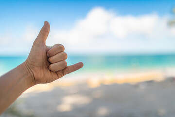 shaka, hand loose hand sign on Hawaii beach background  - Powered by Adobe