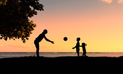 Mother woman playing game sport with little children. Family fun outdoor activity concept