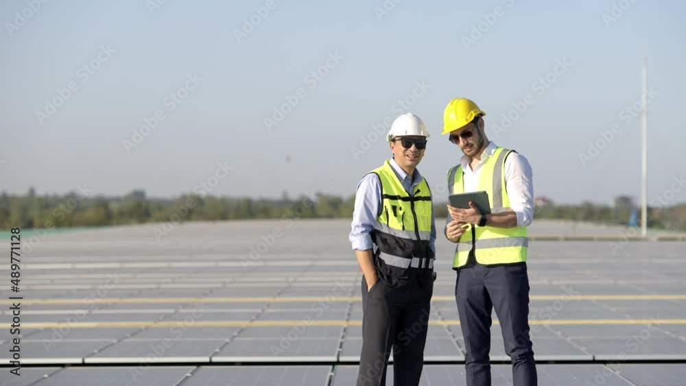 Wall mural professional engineer using drone and digital tablet maintaining solar cell panels together on build