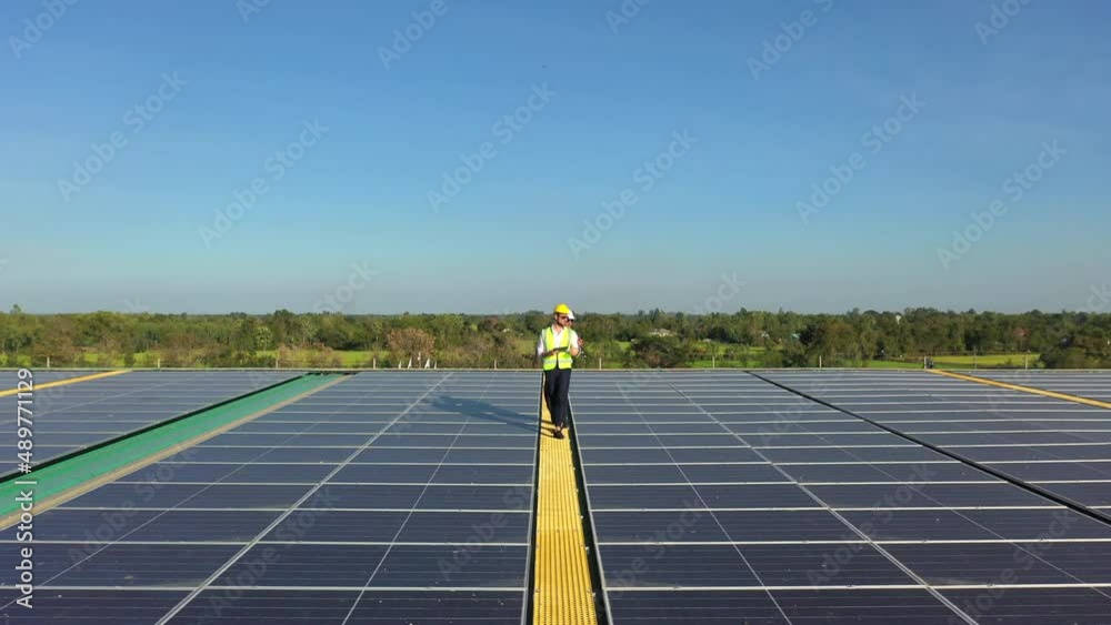 Wall mural professional engineer using drone and digital tablet maintaining solar cell panels together on build