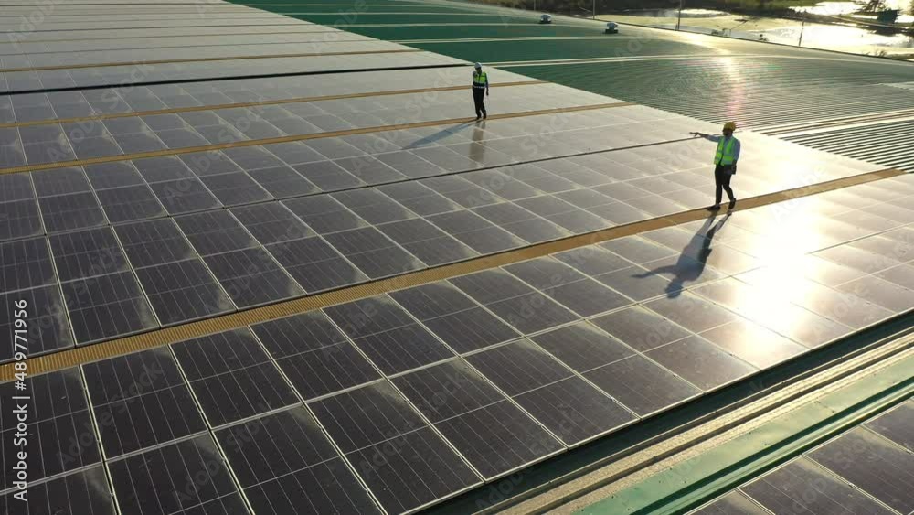 Wall mural professional engineer using drone and digital tablet maintaining solar cell panels together on build