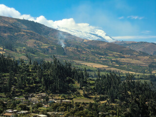 Landscape with rustic houses in Huaraz - Peru, with a snowy peak.